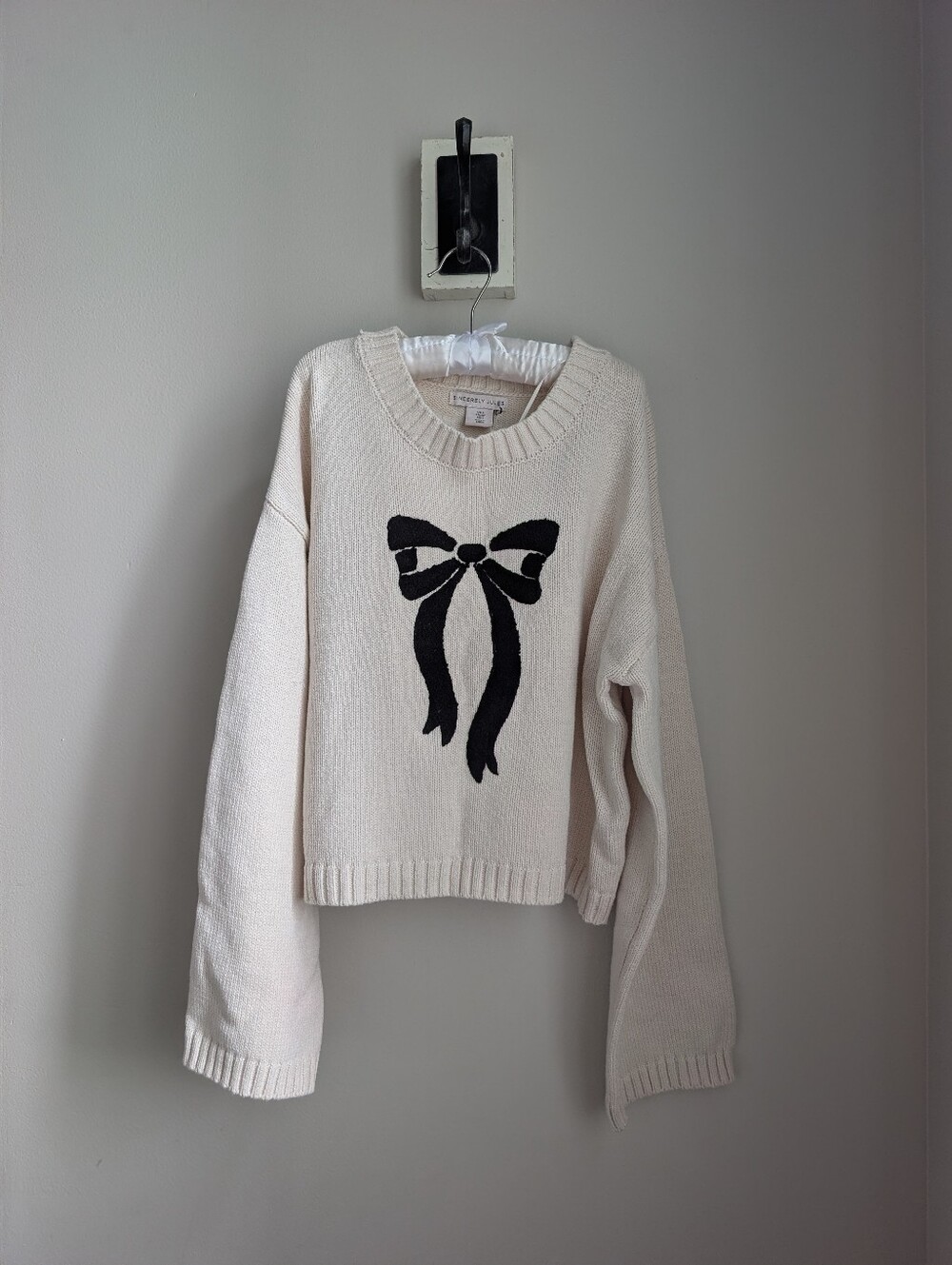 Women’s cream crewneck sweater with black bow Size Small NWOT Sincerely Jules
